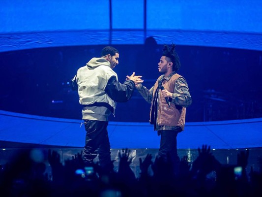 NOTTINGHAM, UNITED KINGDOM - MARCH 16: Drake and The Weeknd performs on stage during a date of his 'Nothing Was the Same' 2014 World Tour at Nottingham Capital FM Arena on March 16, 2014 in Nottingham, England. (Photo by Ollie Millington/WireImage)