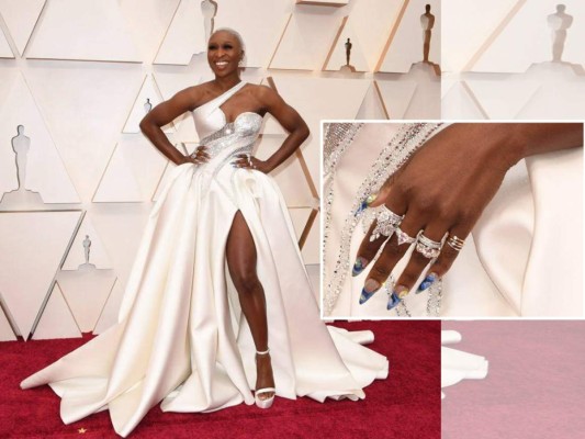 La única artista negra nominada en los Oscars, Cynthia Erivo, impactó con un voluminoso vestido blanco con brillos, pero lo que se destacó del look fueron sus uñas. El nail art de la actriz era XXL, puntiagudo y muy colorido en diferentes tonos azules y un poco de dorado. Lo combinó con muchas anillos brillantes.