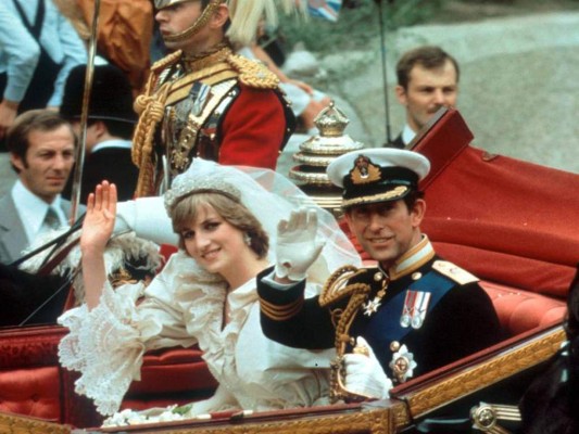 (FILES) In this file photo taken on June 02, 2021 the wedding dress of Diana, Princess of Wales is seen on display at an exhibition entitled 'Royal Style in the Making' at Kensington Palace in London. - London, July 29, 1981. In front of a jubilant crowd and 750 million television viewers, Prince Charles, eldest son of Elizabeth II, married the shy and blushing Diana Spencer. A 'wedding of the century' that will turn into a tragedy. (Photo by JUSTIN TALLIS / AFP)
