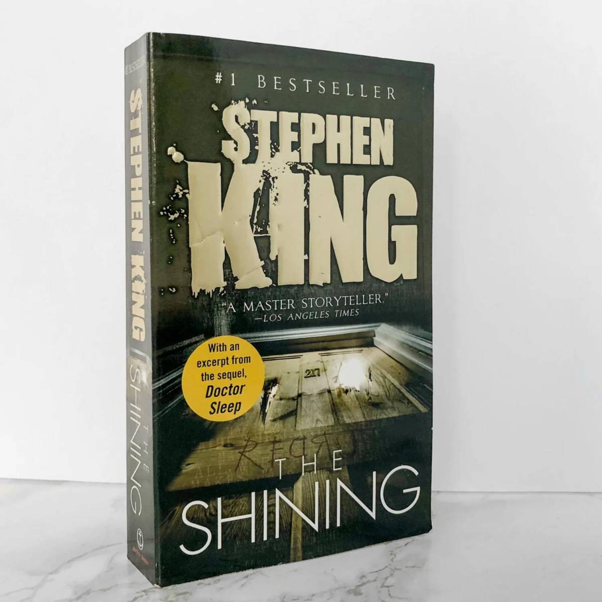 THE SHINING by STEPHEN KING. La tercera novela de terror de Stephen King se convirtió en un clásico del género. La obra gira en torno al escritor Jack Torrance, quien es contratado como cuidador del hotel Overlook, ubicado en lo alto de las montañas de Colorado y a donde se muda en el invierno junto a su familia. Los Torrance no imaginan que el hotel tiene personalidad propia, y actúa de forma psíquica: manipula a los vivos y muertos para sus propios propósitos; y magnífica los poderes psíquicos de cualquiera que reside allí haciéndole ver horribles escenas del pasado del hotel. 