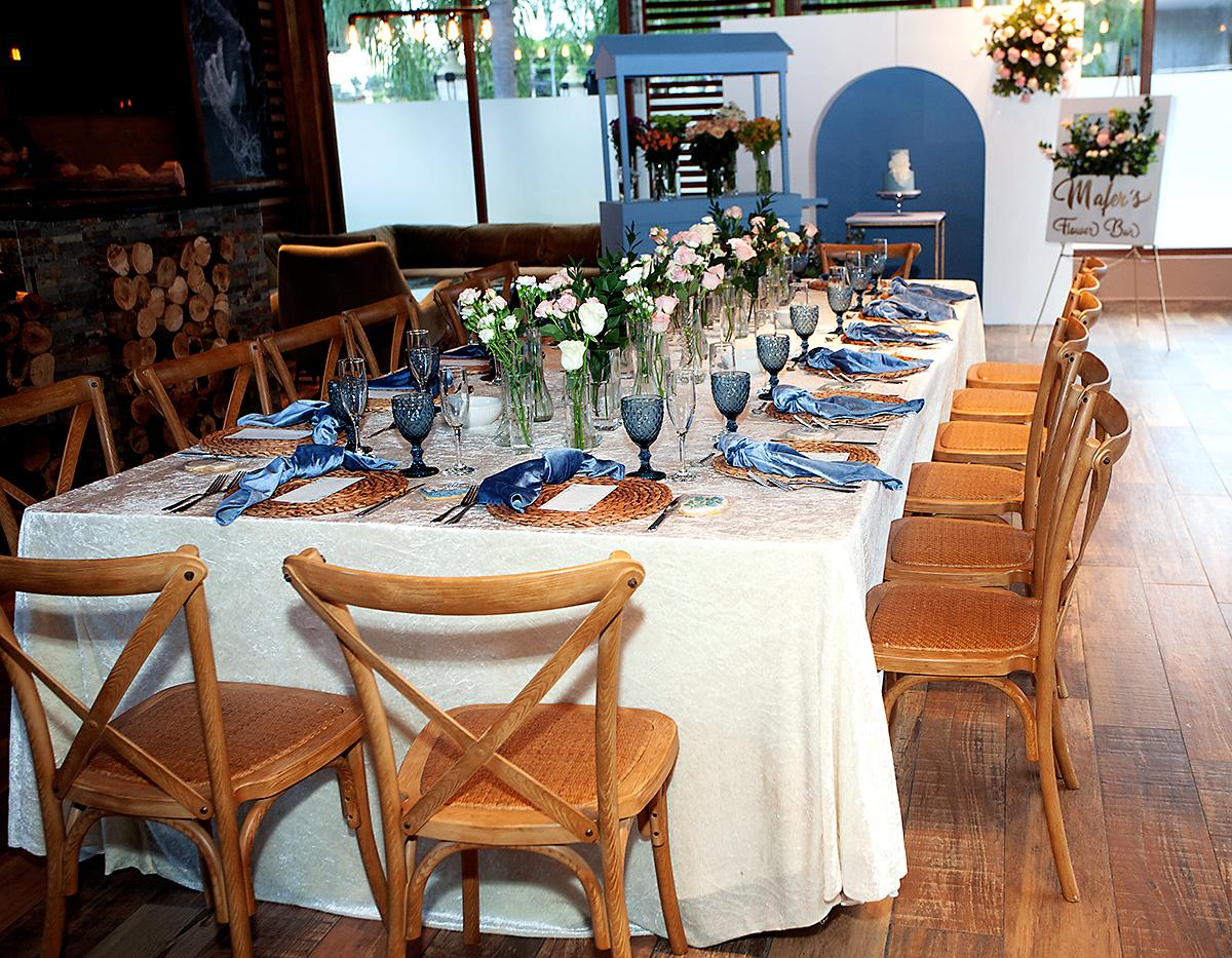 Mesa estilo imperial vestida en fina mantelería con sillas crossback.