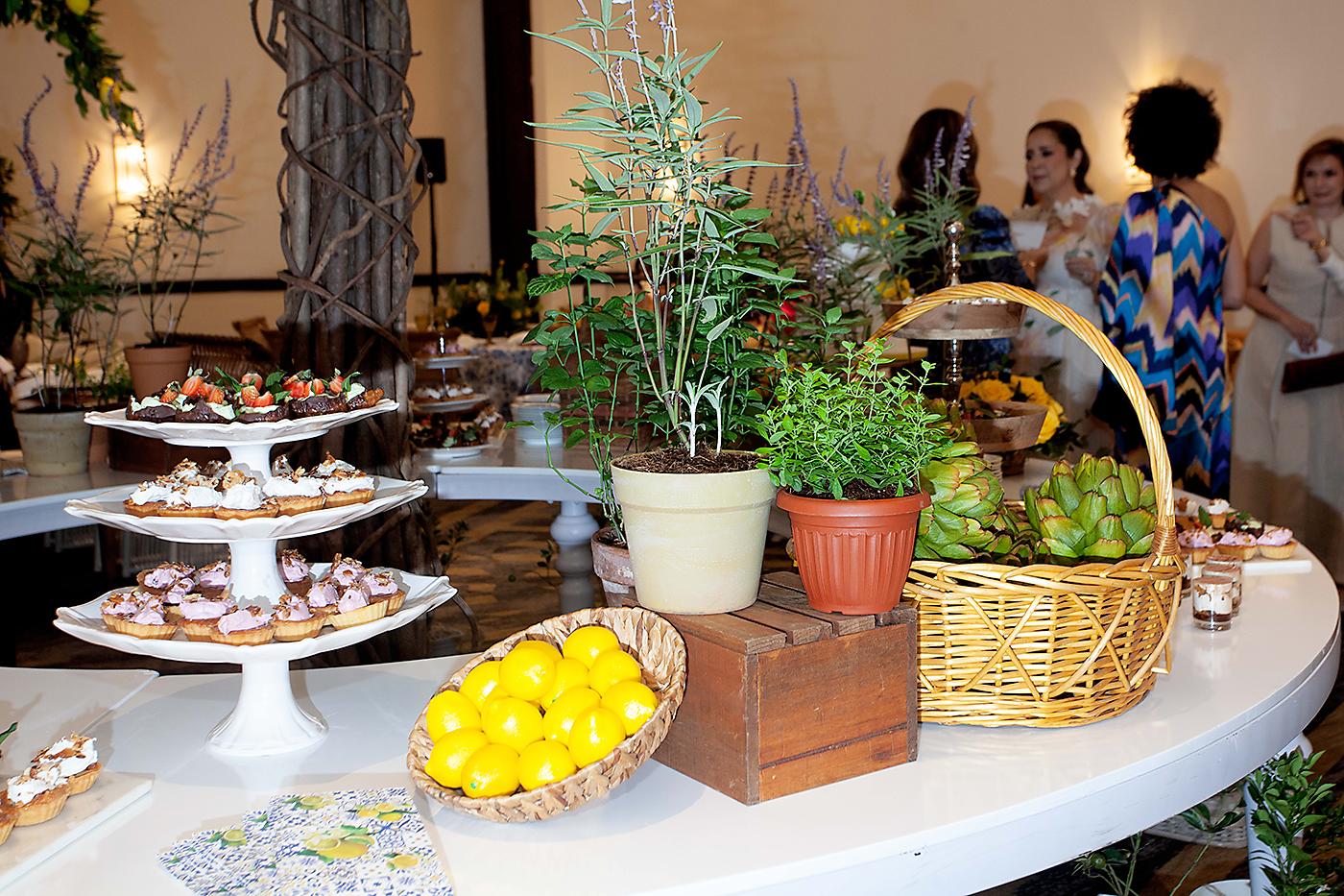 Estación de postres adornada con plantas de lavanda, hierbabuena y limones.