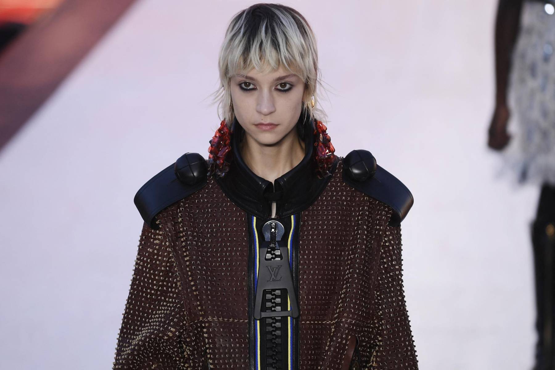 Con abrigos oversize, zippers gigantes y botas estampadas con un damero blanco y negro, el director artístico de las colecciones mujer, Nicolas Ghesquière, parecía proponer un paseo con Alicia en el país de las Maravillas, pero en versión rock y moderna.