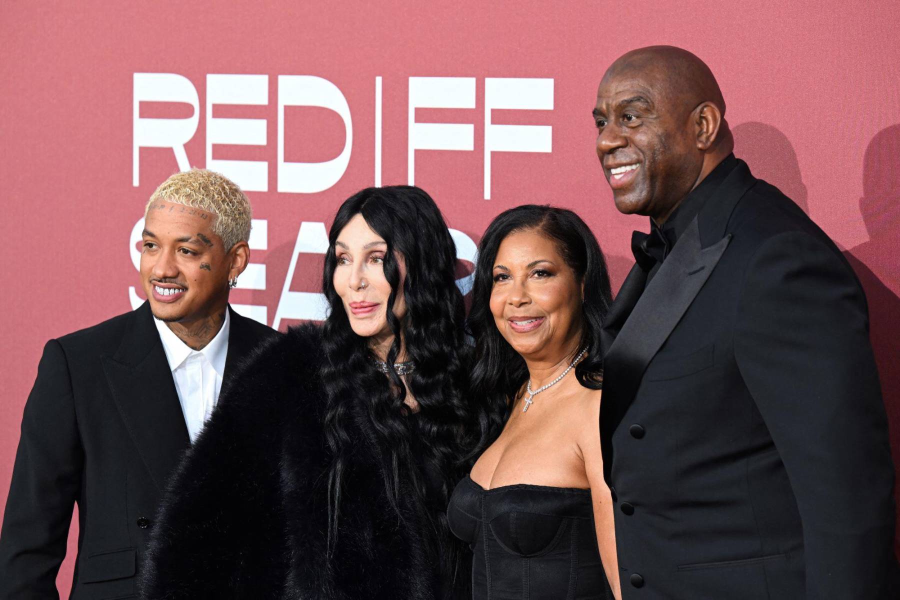 Alexander Edwards y Cher con Magic Johnson y su esposa Cookie 