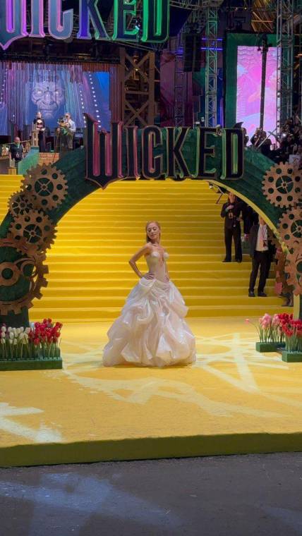 La premier de <i>”Wicked”</i> en la Ciudad de México fue un evento lleno de emoción y expectativas desbordadas, donde cientos de fanáticos se dieron cita en el Auditorio Nacional para ver a sus estrellas favoritas. La llegada de celebridades como Ariana Grande, Cynthia Erivo, Danna Paola y Ceci de la Cueva elevó la euforia al punto de que algunos asistentes rompieron el cerco de seguridad en su entusiasmo por acercarse a la alfombra amarilla. A pesar de este incidente, el evento continuó sin mayores inconvenientes, dejando momentos inolvidables para los seguidores de esta icónica historia musical.