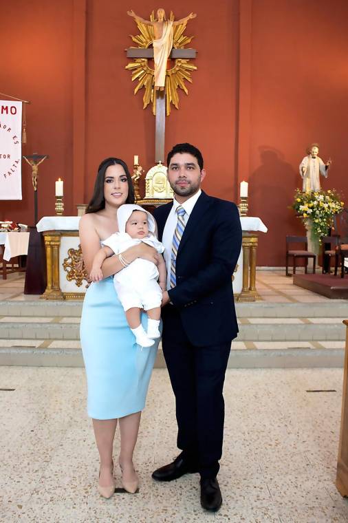 Daniela y Willy Alvarenga, con su hijo Daniel Emilio, durante la ceremonia de bautizo.