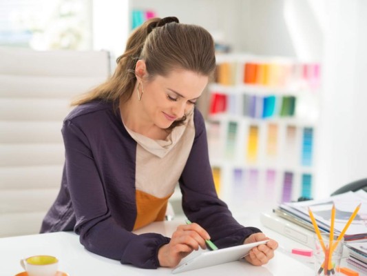 Fashion designer working on tablet pc in office