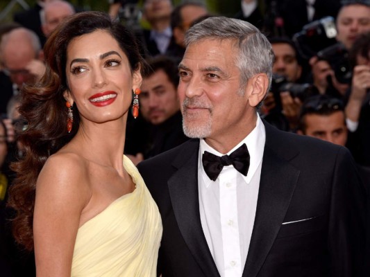 George y Amal reducirán sus viajes