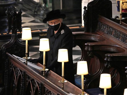 Queen Elizabeth II watches as pallbearers carry the coffin of Britain's Prince Philip, Duke of Edinburgh during his funeral inside St George's Chapel in Windsor Castle in Windsor, west of London, on April 17, 2021. - Philip, who was married to Queen Elizabeth II for 73 years, died on April 9 aged 99 just weeks after a month-long stay in hospital for treatment to a heart condition and an infection. (Photo by Yui Mok / POOL / AFP)