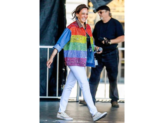 Kamala Harris saluda durante el Pride Parade en San Francisco en junio de 2019. Como un claro mensaje de apoyo, vistió una jacket de pedrería de colores by Levi's con jeans blancos y cómodos Converse.