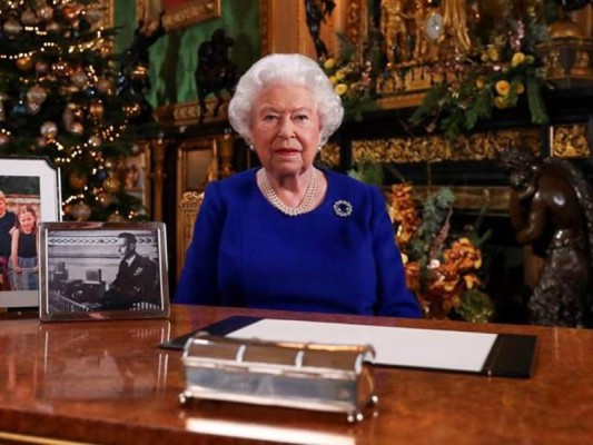 In this image released Tuesday Dec. 24, 2019, Britain's Queen Elizabeth II poses for a photo, while recording her annual Christmas Day message to the nation, at Windsor Castle, England. Excerpts released by Buckingham Palace of the pre-recorded message to be broadcast on TV on Christmas Day, show the Queen acknowledging that both Britain and her family have endured a difficult year. (Steve Parsons/pool via AP)