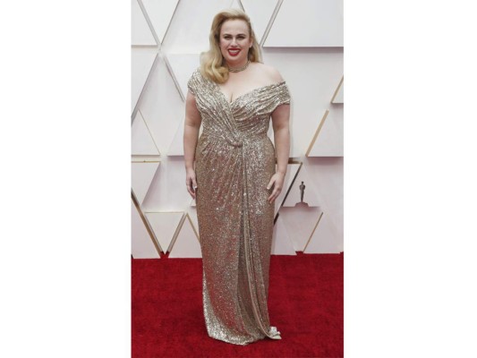 Rebel Wilson lució un impactante vestido de paillettes dorados con drapeado y escote off shoulders