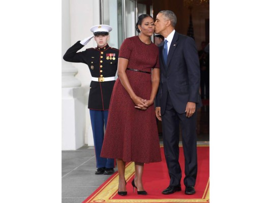 Michelle y Barack Obama en un gesto cariñoso en la Casa Blanca, donde recibieron al nuevo mandatario. Un discreto vestido de Jason Wu en rojo y negro fue la elección discreta de la ex primera dama.