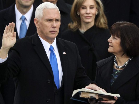El vice president Mike Pence es juramentado mientras su esposa Karen sostiene la biblia durante la 58th Inauguración Presidencial