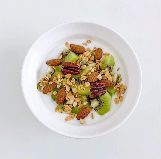 <b>Fruta con un puñado de frutos secos</b><br />Puedes elegir la fruta de tu preferencia, ya sea tropical, ácida o ideal para calmar el antojo de dulce. Al acompañarla con frutos secos, se logra mayor saciedad y se añaden nutrientes esenciales como grasas buenas y minerales.