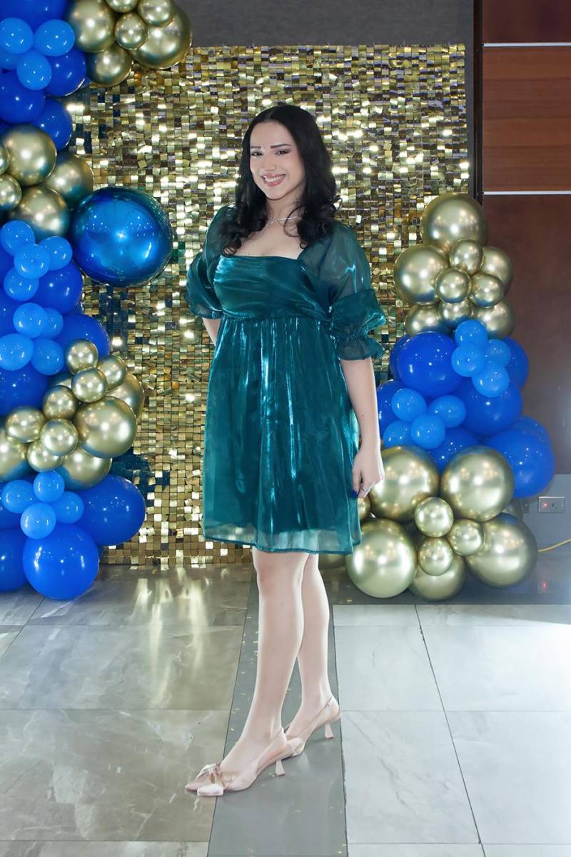 Una decoración alegre con globos y delicados centros de mesa fueron ubicados en las mesas circulares vestidas con los tonos de la institución educativa y completadas con sillas Tiffany en tono dorado.