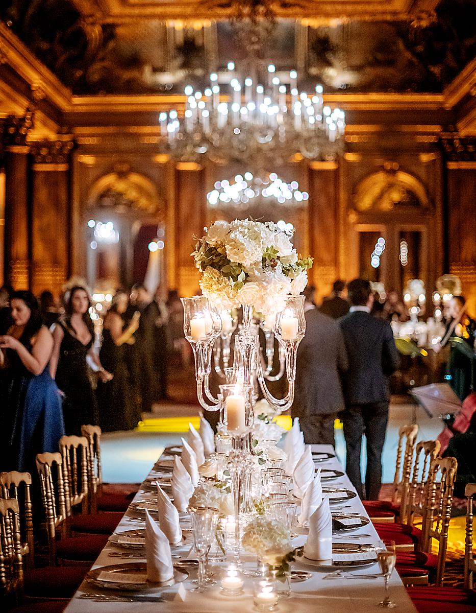 Mesas estilo imperial adornadas con delicados candelabros estilo chandelier adornados con rosas y fina cristalería, combinó perfecto con sillas Tiffany, dispuestas para la ocasión.